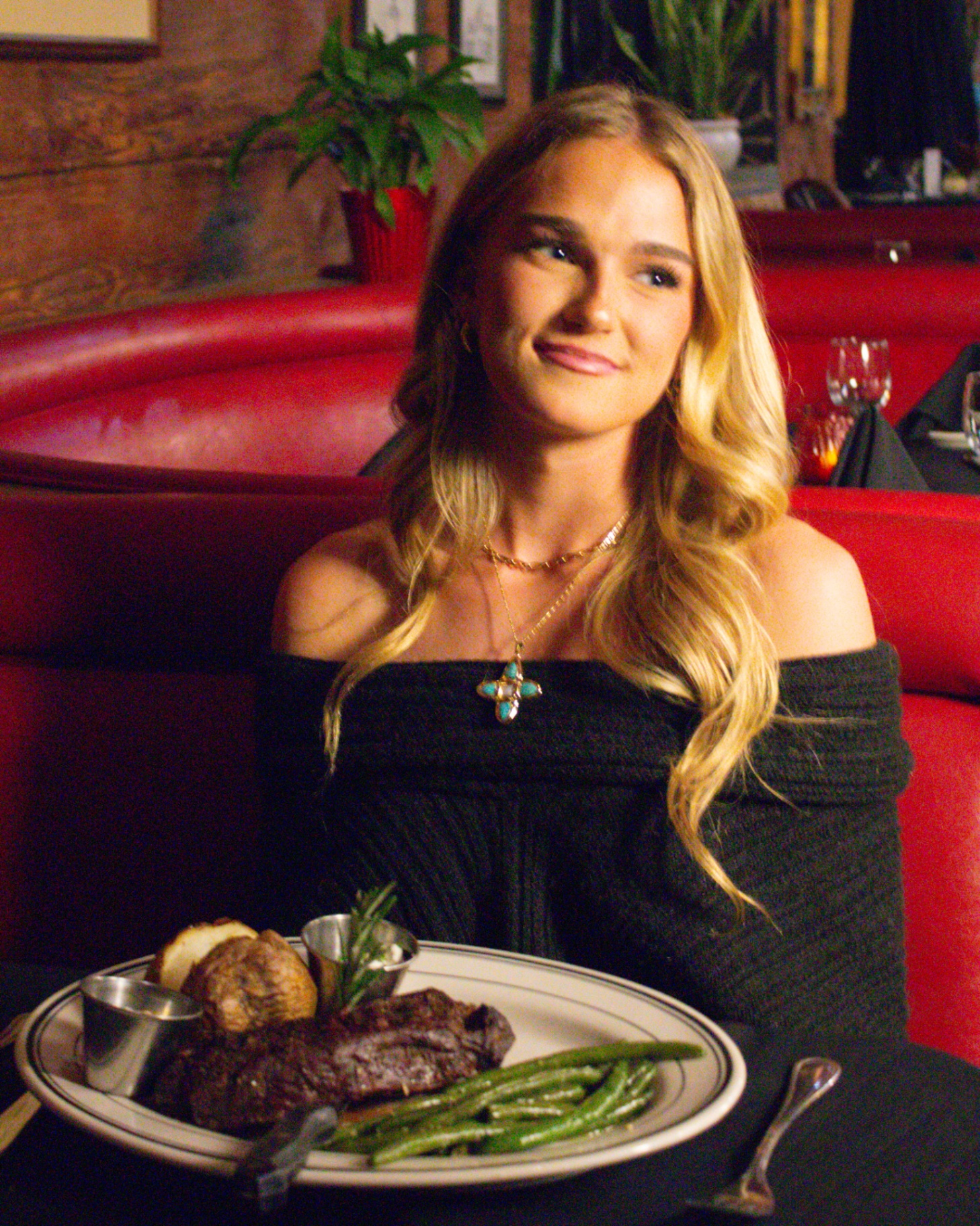 Guest with a steak dinner at a red-booth restaurant